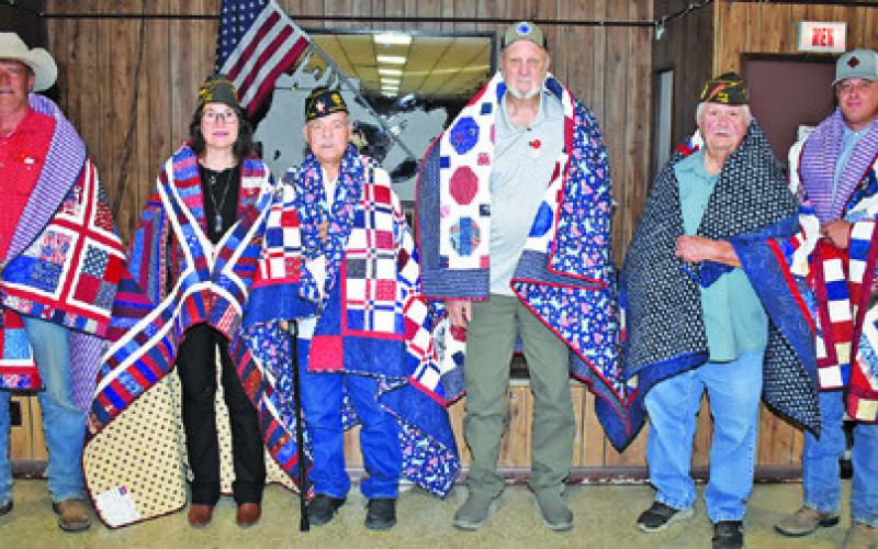 RECEIVING QUILTS OF VALOR were, from left, Robert Norris, Tina Smith, James Kemp, Ronnie Albright, Donny Wood, and Josh Raymond. The quilts were presented at the VFW post.