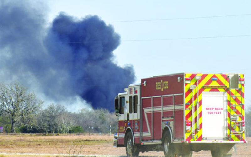 A FIRE TRUCK responds to the oil well fire site off F.M. 2000. Tribune photo by Roy Sanders