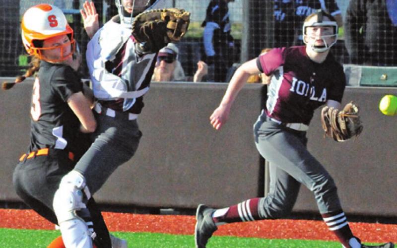 EMMA KOVASOVIC slams into the Iola catcher to score during the Lady Yeguas’ 23-17 win last week. -- Tribune photo by Denise Squier