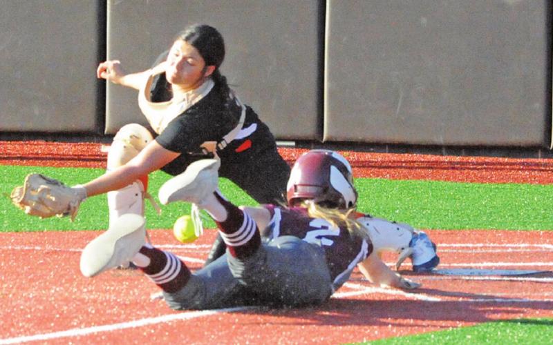 SOMERVILLE’S AVERIE HERNANDEZ attempts to tag out an Iola player at the plate during their district game last week.