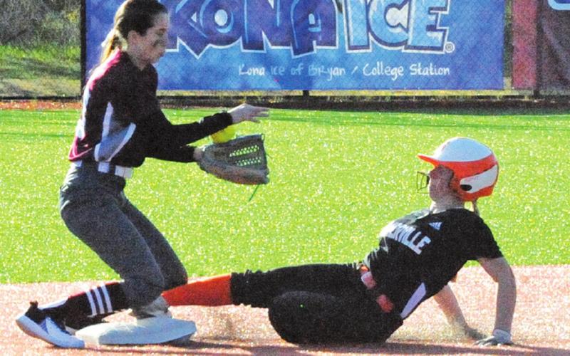 SOMERVILLE’S ABIGAIL FLENCHER slides safely into second base during the Somerville-Iola game last week in Bryan.