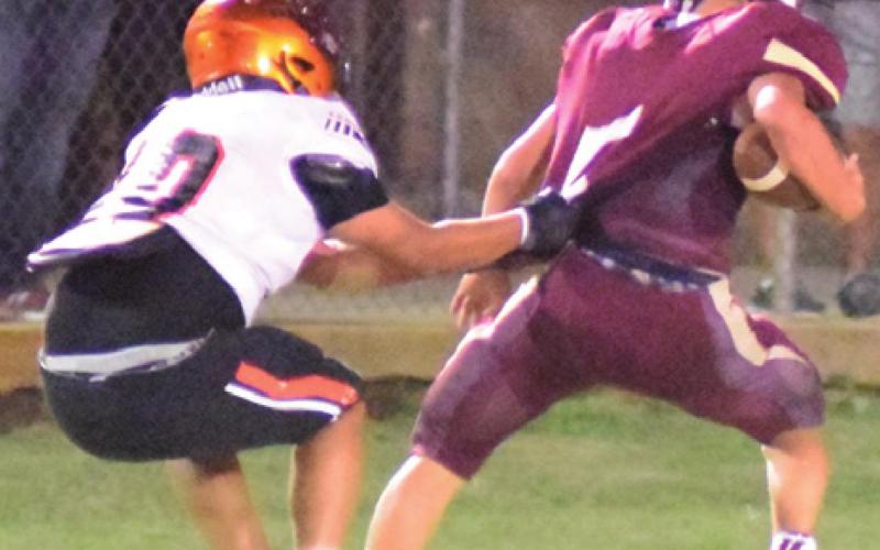 SOMERVILLE’S ISAAC SANCHEZ pulls down Milano’s quarterback Shiner Thurman during the Yegua-Eagle district opener last Friday night in Milano. -- Tribune photo by Bailey Brown