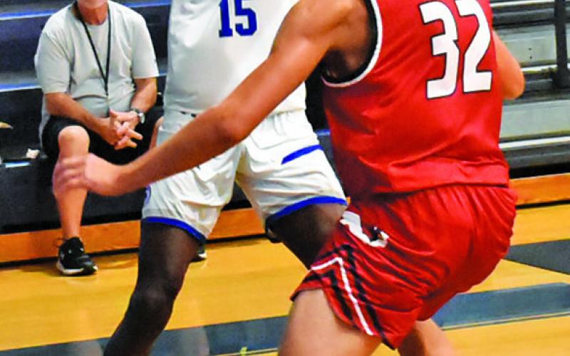 BUD MOORE of Snook gets ready to pass against St. Paul in the Bluejay’s 54-38 win. Tribune photo by Roy Sanders