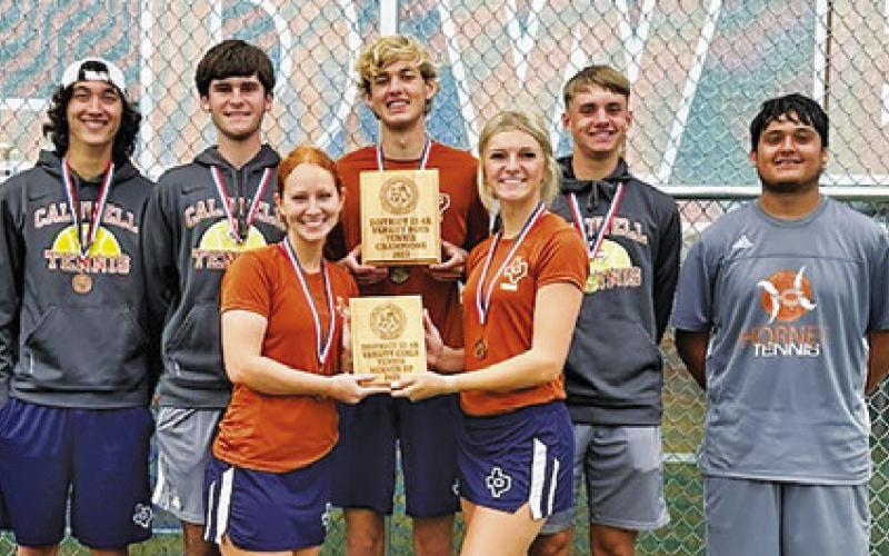 CALDWELL SENIOR TENNIS players proudly display the boys teams’ district champion plaque and girls teams’ district runner-up plaque at last week’s District Tennis Tournament in Caldwell.