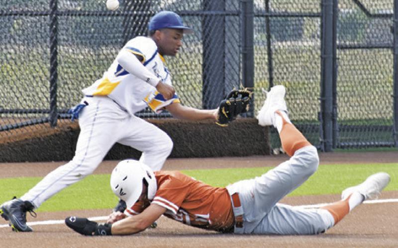 COY BECKA OF Caldwell slides into base against Houston Washington in the bi-district game.