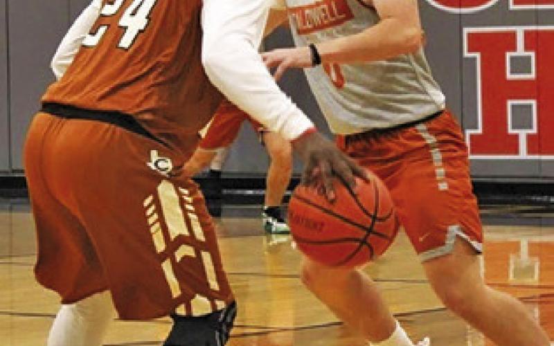 ALUMNI WILLIAM DEERE dribbles the ball for as Cayden Zboril defends in the Caldwell alumni scrimmage on Tuesday, Nov. 11.