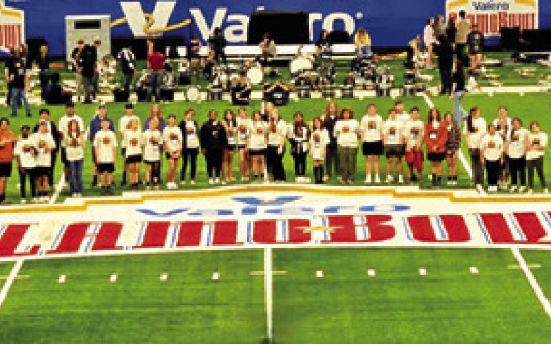 THE CALDWELL HIGH SCHOOL Marching Band poses on the Alamodome field ahead of rehearsal. Photo courtesy of Dr. Jason Levin