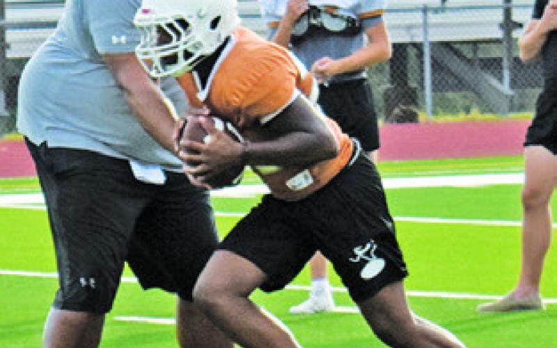 THE CALDWELL HORNETS work on their running game at Monday’s practice.