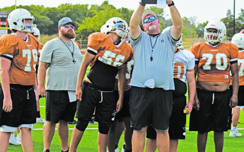 CALDWELL HEAD COACH Sean Witherwax goes over the plays.