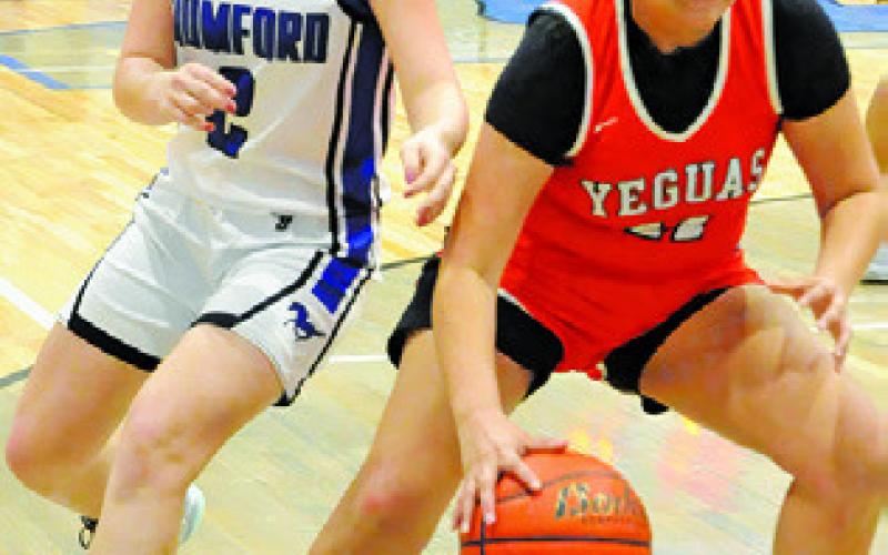 VIVIANNA MUNOZ dribbles down the baseline during the Somerville-Mumford game. Tribune photo by Denise Squier