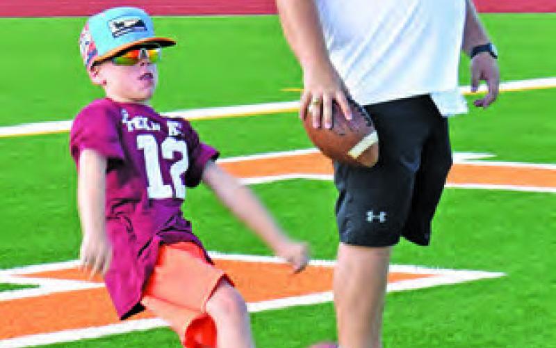 PUNTING SKILLS are taught last Thursday at the Hornet football camp at CHS Stadium.