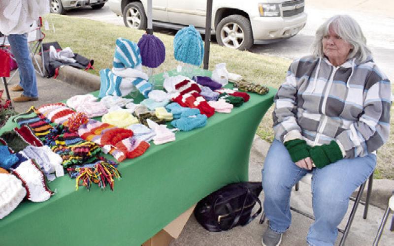 COLLEEN DUNN DISPLAYS these items on Sunday morning at the Farmers Market in Somerville. A large crowd attended.