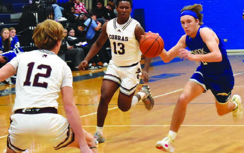 BRETT WITHEM OF Snook moves the ball down court against Vanderbilt Industrial. Snook lost 41-30. Tribune photo by Roy Sanders