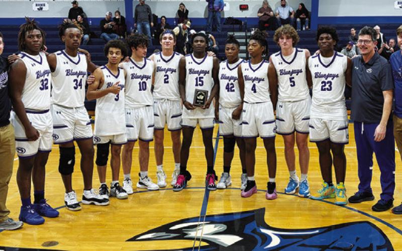 THE SNOOK BASKETBALL team gathers after a third-place finish at their tournament.