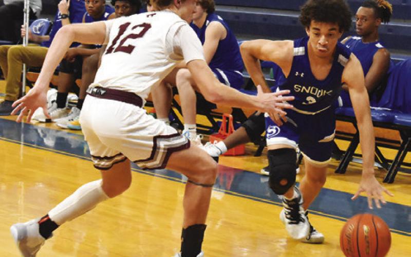 MAX CARTER OF Snook dribbles the ball against Vanderbilt Industrial. Snook finished 2-3 at their tournament. Tribune photo by Roy Sanders