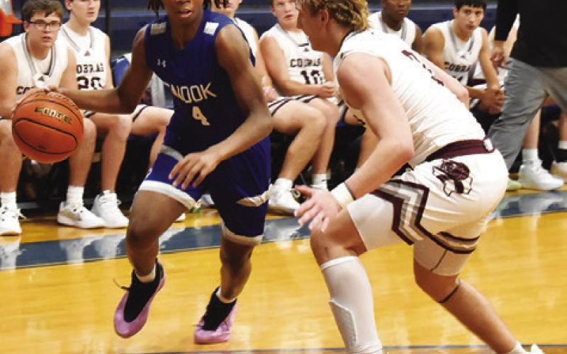 SNOOK’S JOHN CARR dribbles the ball against Vanderbilt Industrial at the Snook High School Tournament. Tribune photo by Roy Sanders