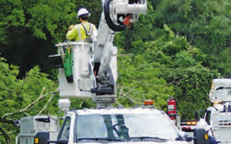 ENTERGY CREWS worked to restore power to Burleson County residents after last Thursday’s storm knocked down power lines.