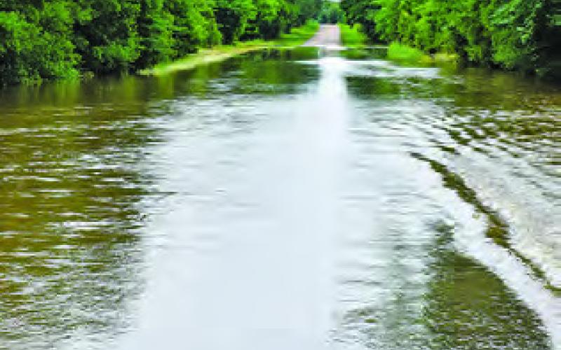 WATER GOES OVER the road on County Road 423 on Friday, May 17.