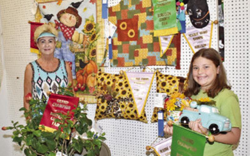 MARY MURPHY won adult grand and reserve in clothing and embellished wear and grand in blooming plants. Her granddaughter Paisly Webb won grand in embellished wear and grand and reserve in floral arrangement in the creative living judging.