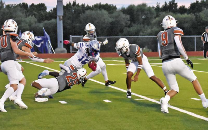 ROGELIO HERNANDEZ OF Caldwell makes a tackle against Crockett. The Hornets won the opener 47-32. Tribune photo by Roy Sanders