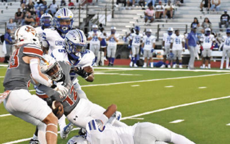DEJUAN MATHIS CARRIES the ball for Caldwell against Crockett. Caldwell won 47-32. Tribune photo by Roy Sanders