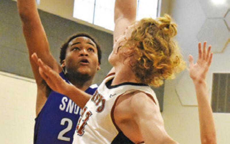 DEKENDRICK DAWSON of Snook takes a shot as Harrison Novak of Caldwell defends. Also defending is Caldwell’s Daniel Cowan. -- Tribune photo by Roy Sanders