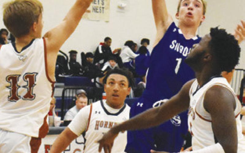 SNOOK’S BRETT Withem takes a shot as Caldwell’s Dylan Chapman, Christian Trinidad and Tee Grimes defend. Caldwell won 62-37.