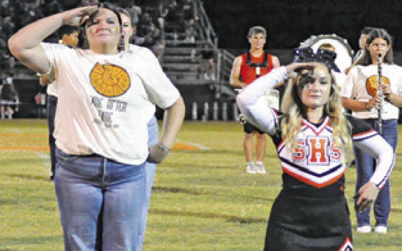 SOMERVILLE HIGH School Drum Majors Aubrey Kovasovic and Savannah Eschete lead the band during the halftime performance.