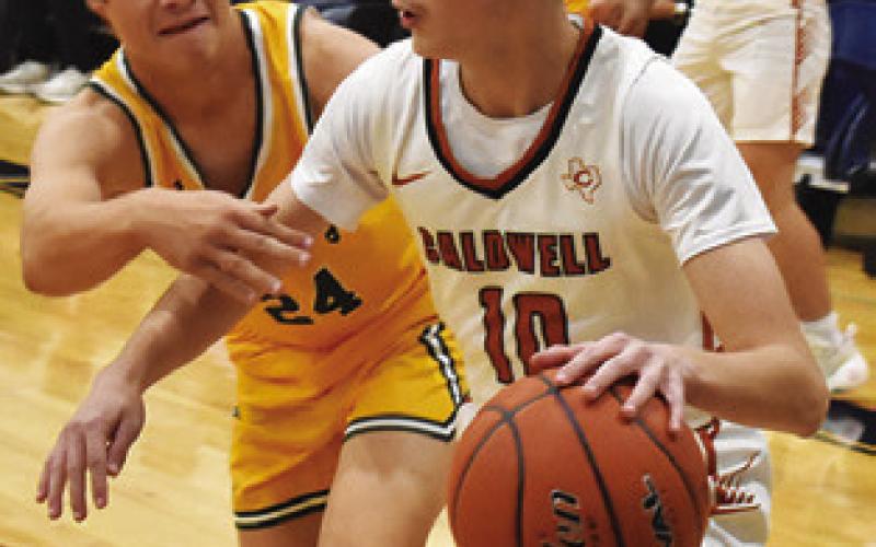 LOGAN COLBERT of Caldwell dribbles the ball against Little River-Academy. Tribune photo by Roy Sanders