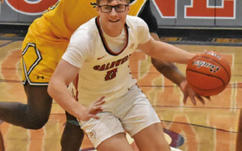 CAYDEN ZBORIL of Caldwell dribbles past this Little River-Academy defender. Tribune photo by Roy Sanders