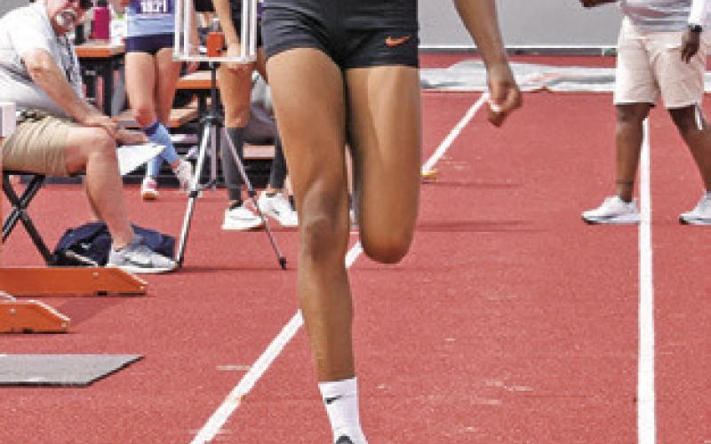 CALDWELL’S JAE MATHIS leaps for the bronze medal in the Class 4A girls’ long jump at the UIL State Track &amp;amp; Field Meet last Thursday in Austin.