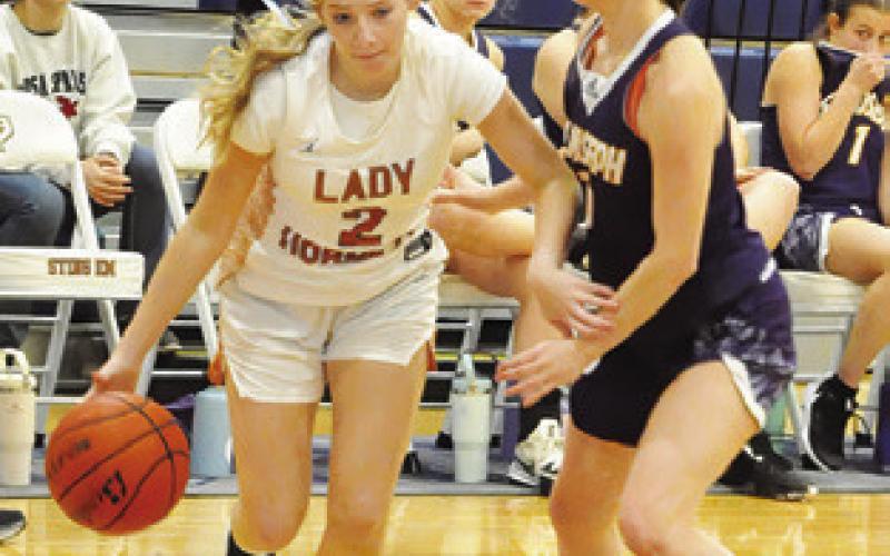 MAYZI WITHERWAX drives the ball down the baseline during the Caldwell-St. Joseph’s game on Friday at Hornet Gym. Tribune photo by Denise Squier