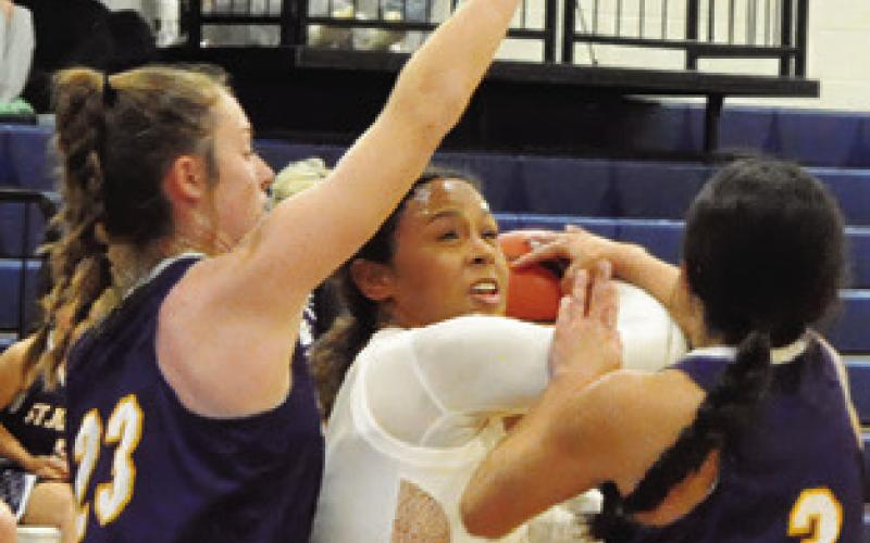 AVELYNN O’RILEY is fouled in the paint during the Caldwell-St. Jo’s game on Friday. Tribune photo by Denise Squier
