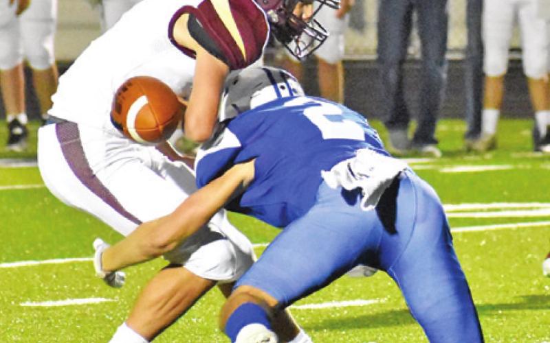SNOOK’S LANCE LARA makes a jarring tackle and causes this fumble against Milano. -- Tribune photo by Roy Sanders