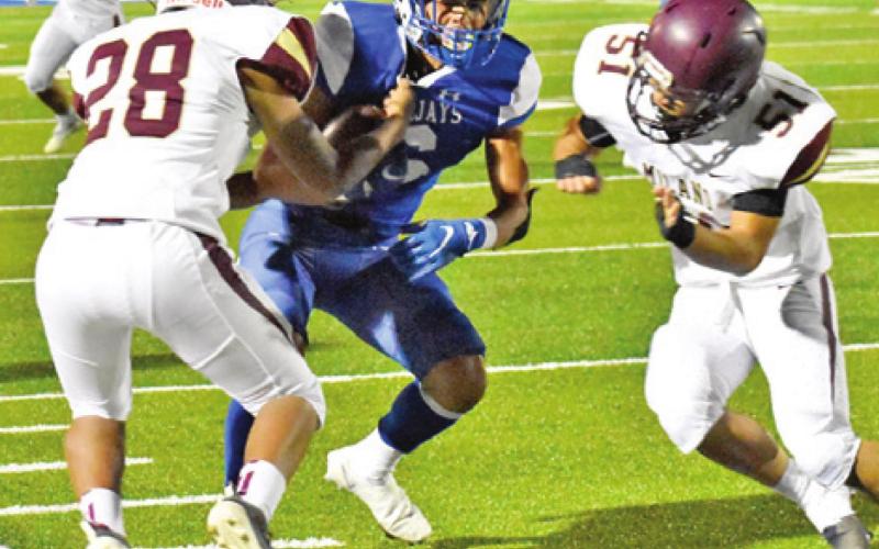 SNOOK’S JOSE GARCIA catches the ball as these defenders approach.
