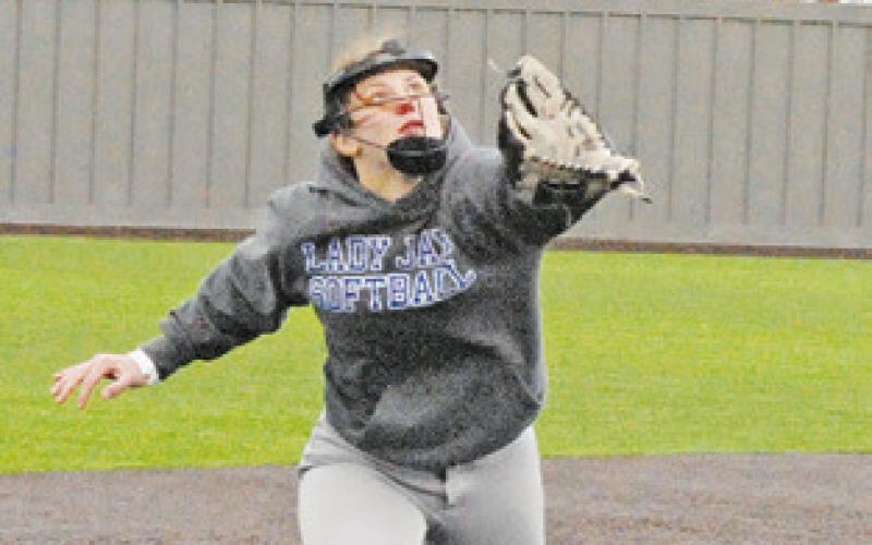 PAYTON SODOLAK sets her sights on a fly ball during the Snook-Burton game last week in Thrall.