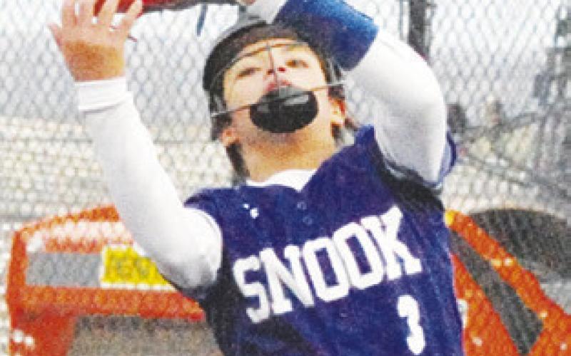 MARISSA BATISTE catches a fly ball near the pitcher’s circle during the Snook-Burton last week at the Thrall Invitational Softball Tourament.
