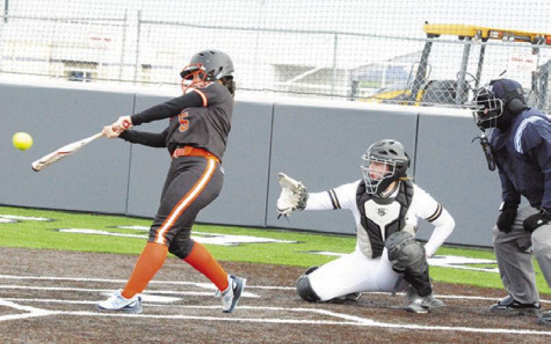 SOMERVILLE’S AVERIE HERNANDEZ hits a double, hitting the fence, during the Lady Yeguas’ win over Giddings last Thursday in the Thrall Invitational Softball Tournament. -- Tribune photo by Denise Squier