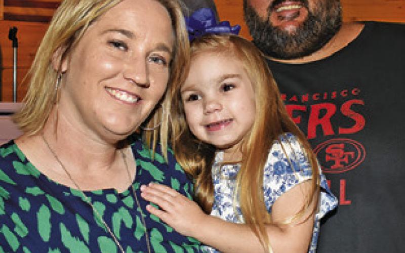 LYNNLEE KOCUREK joins her parents Blake and Marsha Kocurek at Lynnlee’s fundraiser held on Saturday, Oct. 18, in Dime Box.