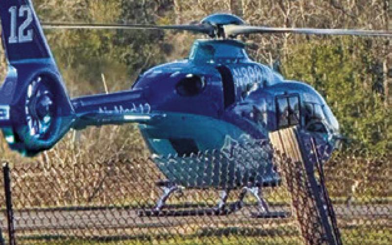 A HELICOPTER lands at the scene of this two-vehicle fatal accident on Wednesday, March 5, on State Highway 21 East.