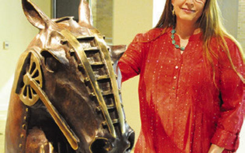 LOCAL ARTIST and art teacher Clover Cochran poses with one of her pieces of bronze work on display in the “Practice What We Teach” exhibit at the Reynolds Gallery at the Memorial Student Center at Texas A&amp;amp;M.