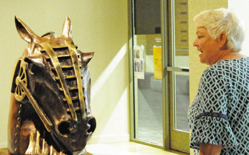 THIS LADY WAS IN AWE OF this artwork by Burleson County’s Clover Cochran. Her art is on display in the “Practice What We Teach” exhibit at the Reynolds Gallery at the Memorial Student Center.