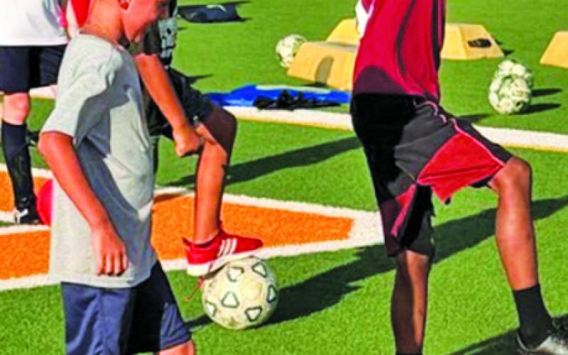 ATHLETES ATTENDING Hornet Soccer Camp work on their footwork skills.