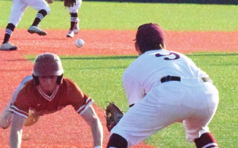 CALDWELL’S BRYCE BLINKA attempts to steal third base, trying to beat the throw by the Troy shortstop during the Hornets’ playoff series against the Trojans. -- Tribune photo by Denise Squier