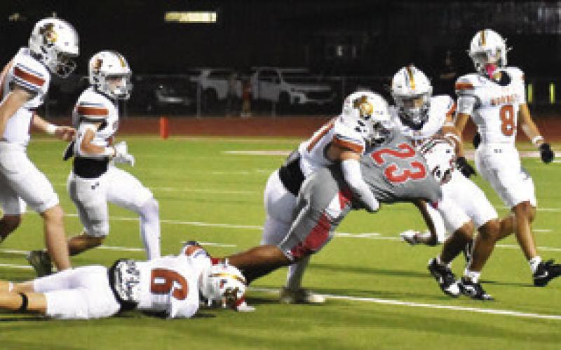 KYSON STRANGE AND Gus Naquin make a tackle in the season finale against Bellville. Tribune photo by Roy Sanders