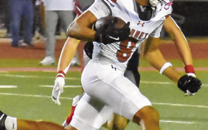 DYLAN CARTER runs with the ball against the Bellville defense. Tribune photo by Roy Sanders