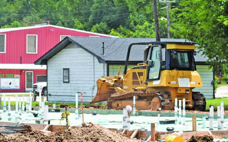 A CONSTRUCTION CREW works at the new Taco Bell location off State Highway 21 West.