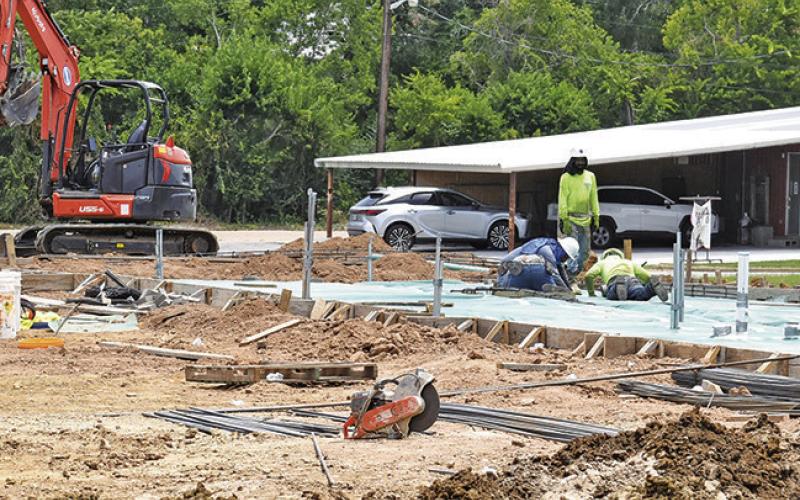 CONSTRUCTION CREW works at the Taco Bell site on Monday, June 30, off State Highway 21. Tribune photo by Roy Sanders
