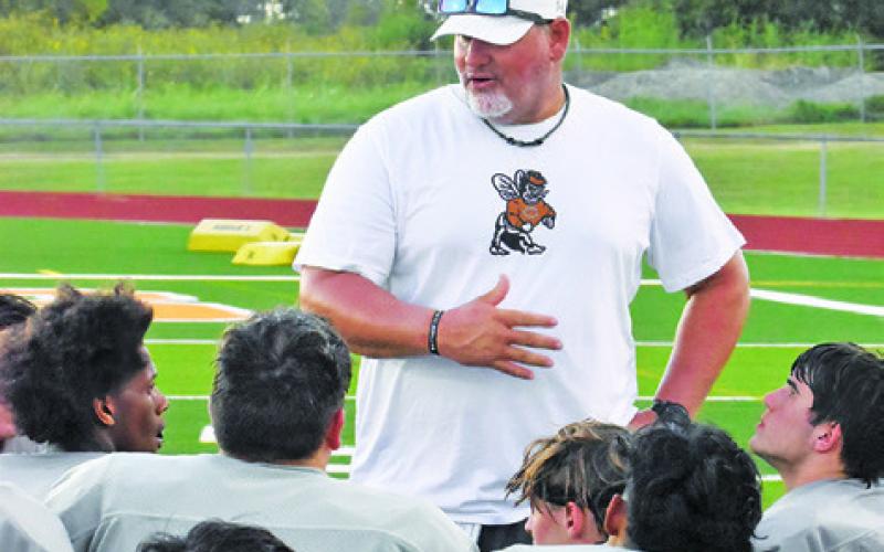CALDWELL HEAD COACH Sean Witherwax addresses his team after the Anderson-Shiro scrimmage. -- Tribune photo by Roy Sanders