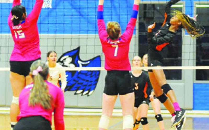 SOMERVILLE’S KARYS ELLIS gets a kill by hitting the ball between Snook’s Karla Lara and Kiley Price last Tuesday. Tribune photo by Denise Squier